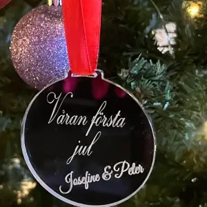 a silver round ornament with a red ribbon and a purple and silver ball